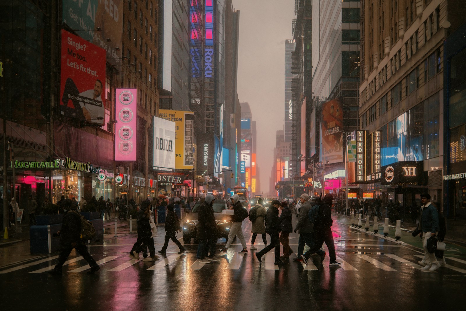 People cross a busy street in a city.